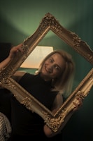 A customer holding a personalized poem plaque, smiling warmly.