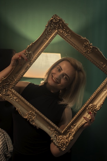 A smiling person holding a personalized photo magnet in their hand