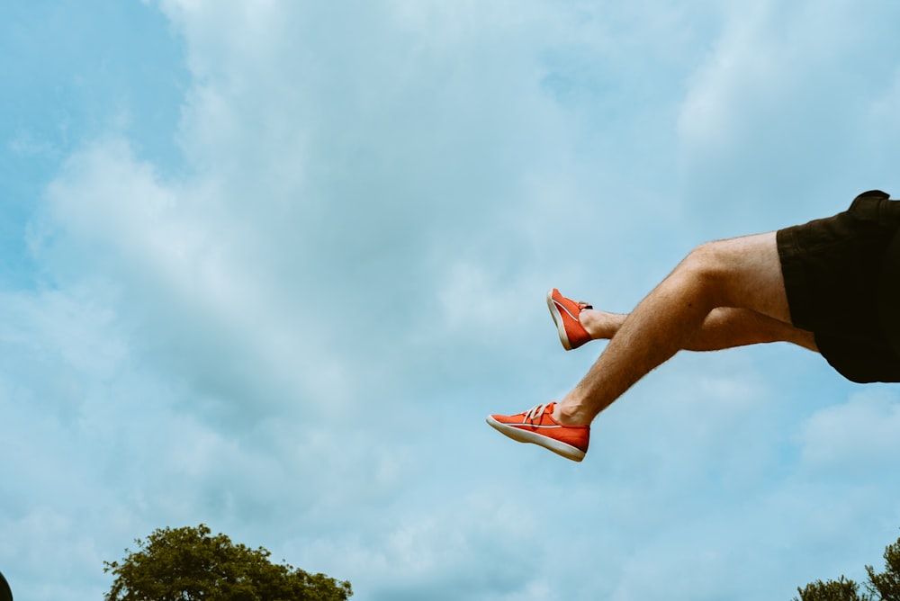 a person jumping in the air with a frisbee