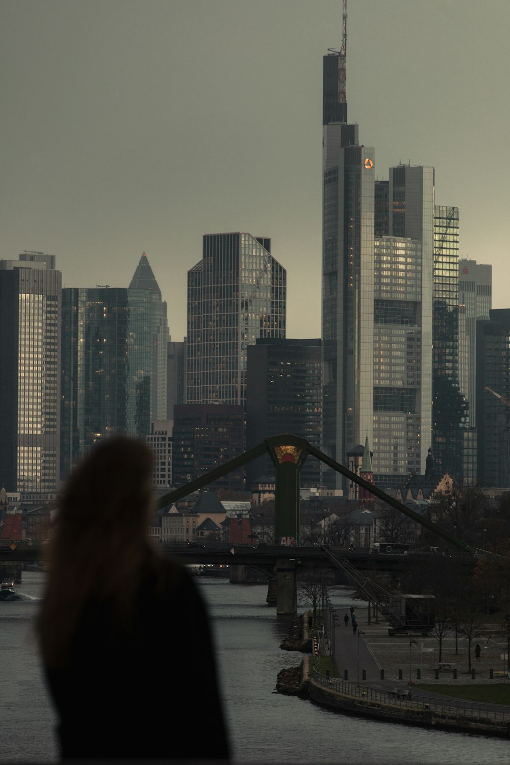 a woman standing in front of a city skyline