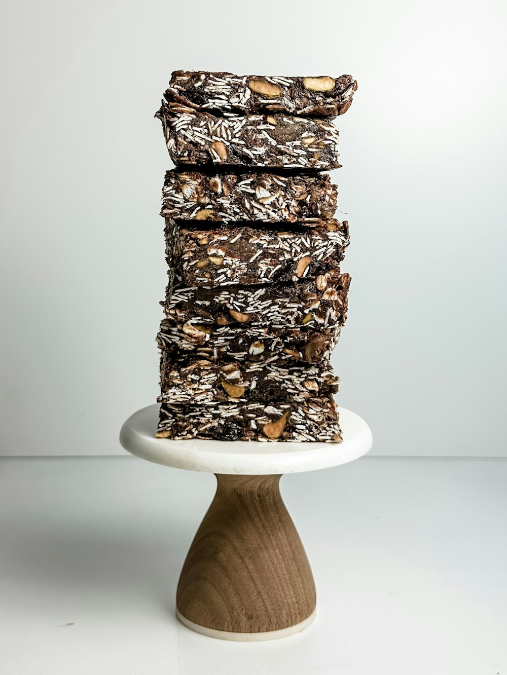 a stack of brownies sitting on top of a white plate