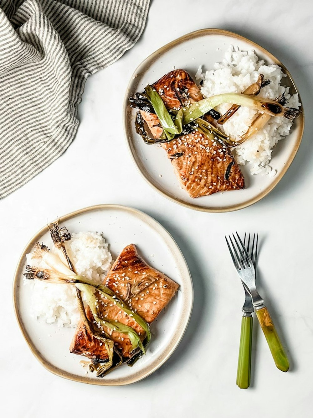 two plates of food on a white table