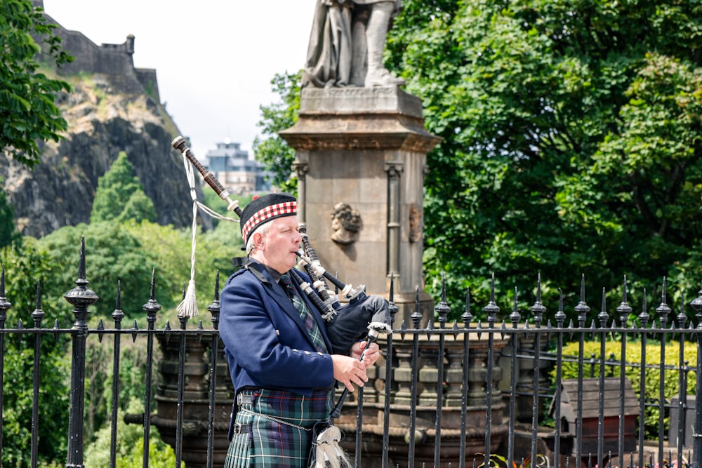 a man in a kilt playing a bagpipe