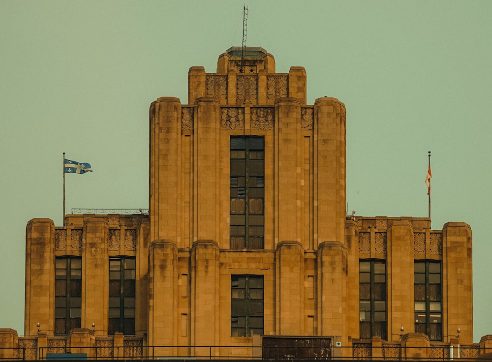 a tall building with a flag on top of it