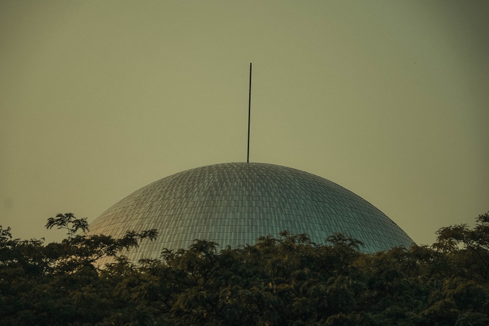 a large dome with a flag on top of it