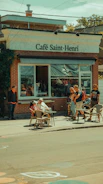 A bustling local cafe with new customers enjoying outdoor seating on a sunny day.
