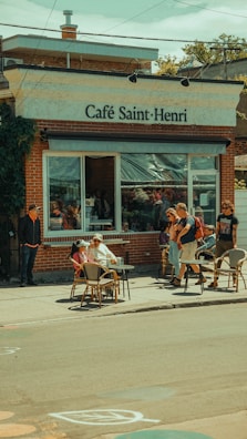 Outdoor seating area at Moa Coffee Bakery on a sunny day, with customers enjoying their meals