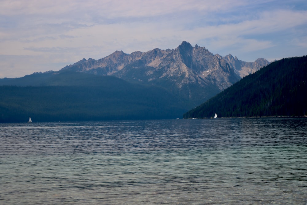 a body of water with mountains in the background