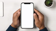 a person holding a phone with a white screen