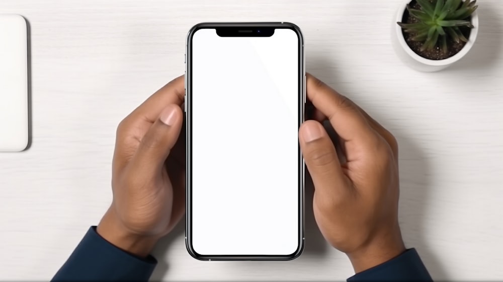 a person holding a phone with a white screen