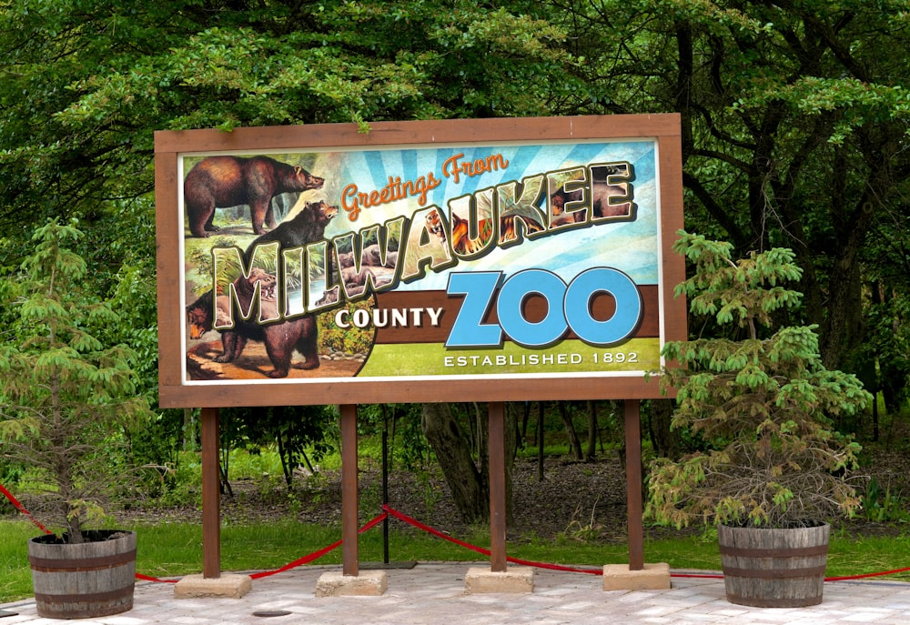 a sign for a zoo with a picture of a bear on it