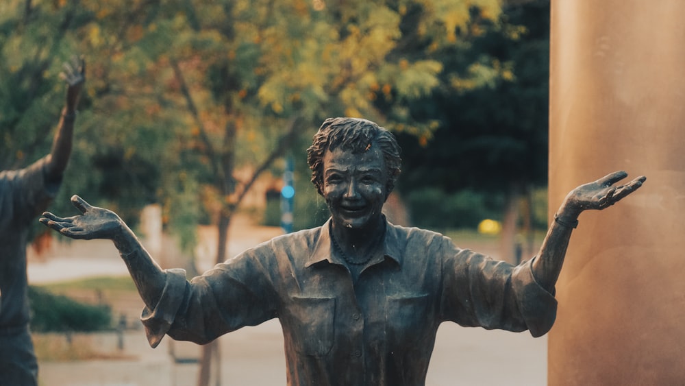 a statue of a man holding his hands up