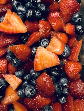 Close-up of vibrant antioxidant-rich berries arranged on a rustic wooden table.