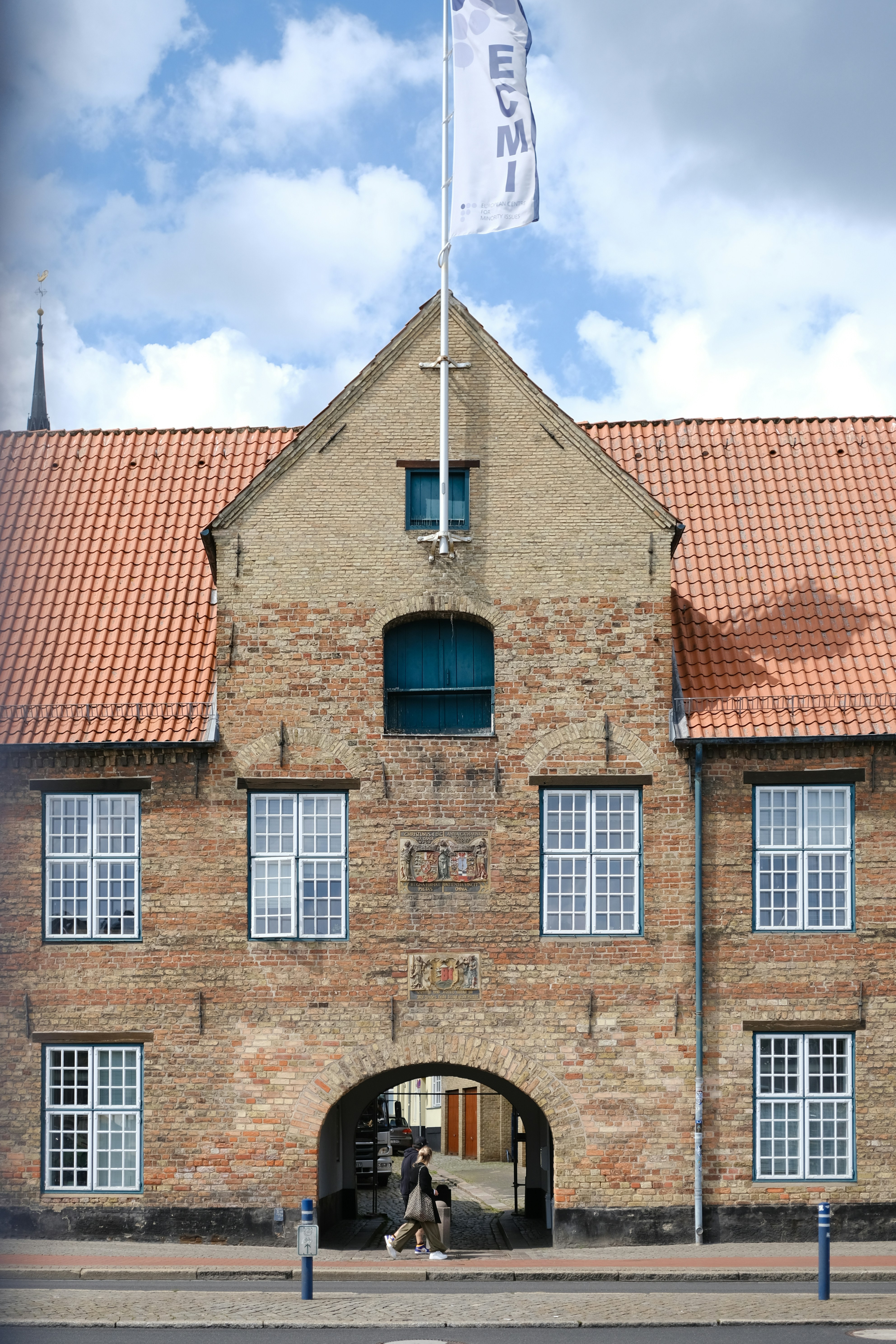 a brick building with a flag on top of it