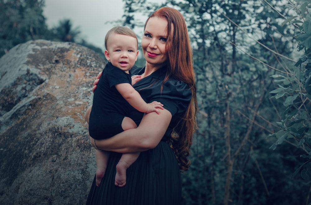 a woman holding a baby in her arms