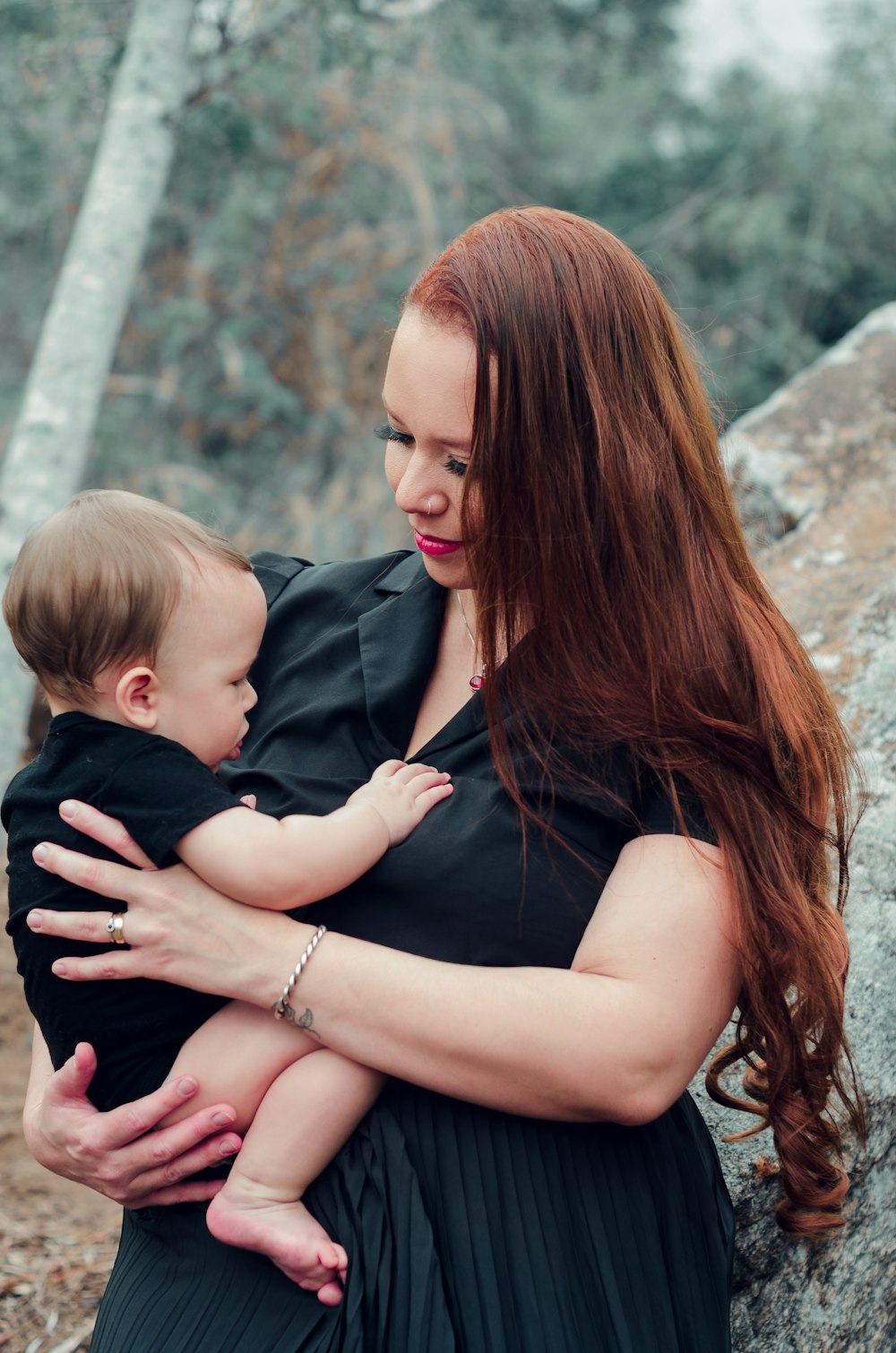 a woman holding a baby in her arms