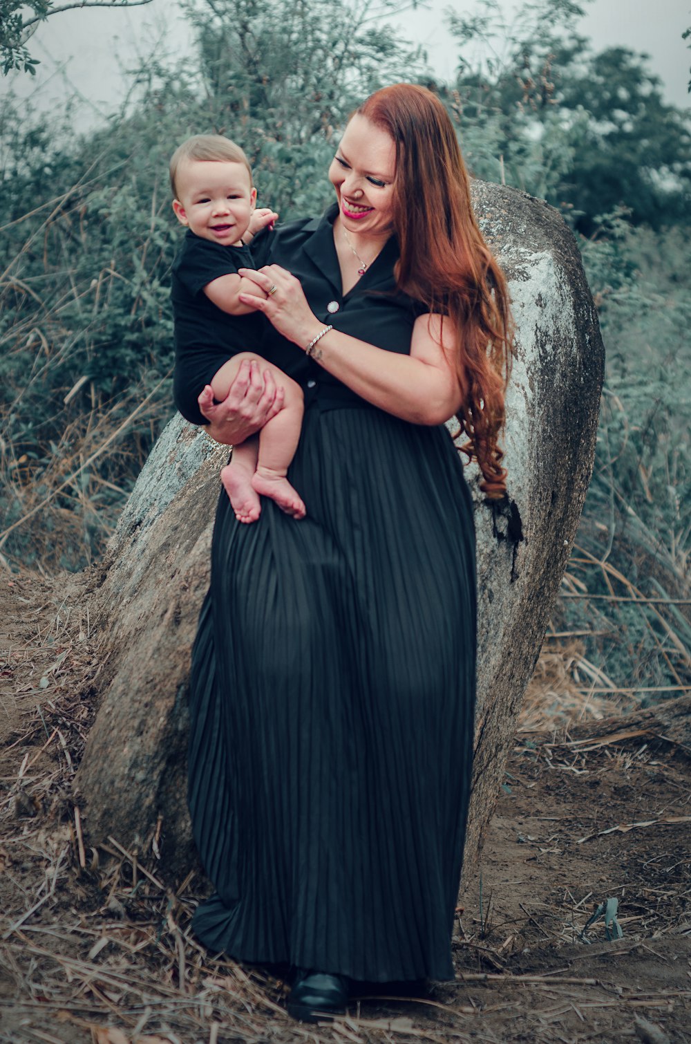 a woman holding a baby in her arms