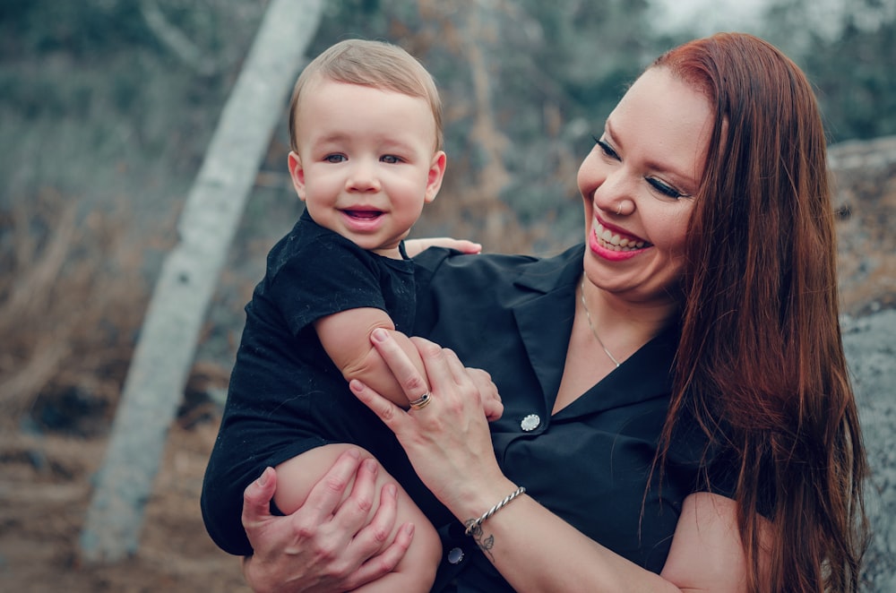 a woman holding a small child in her arms