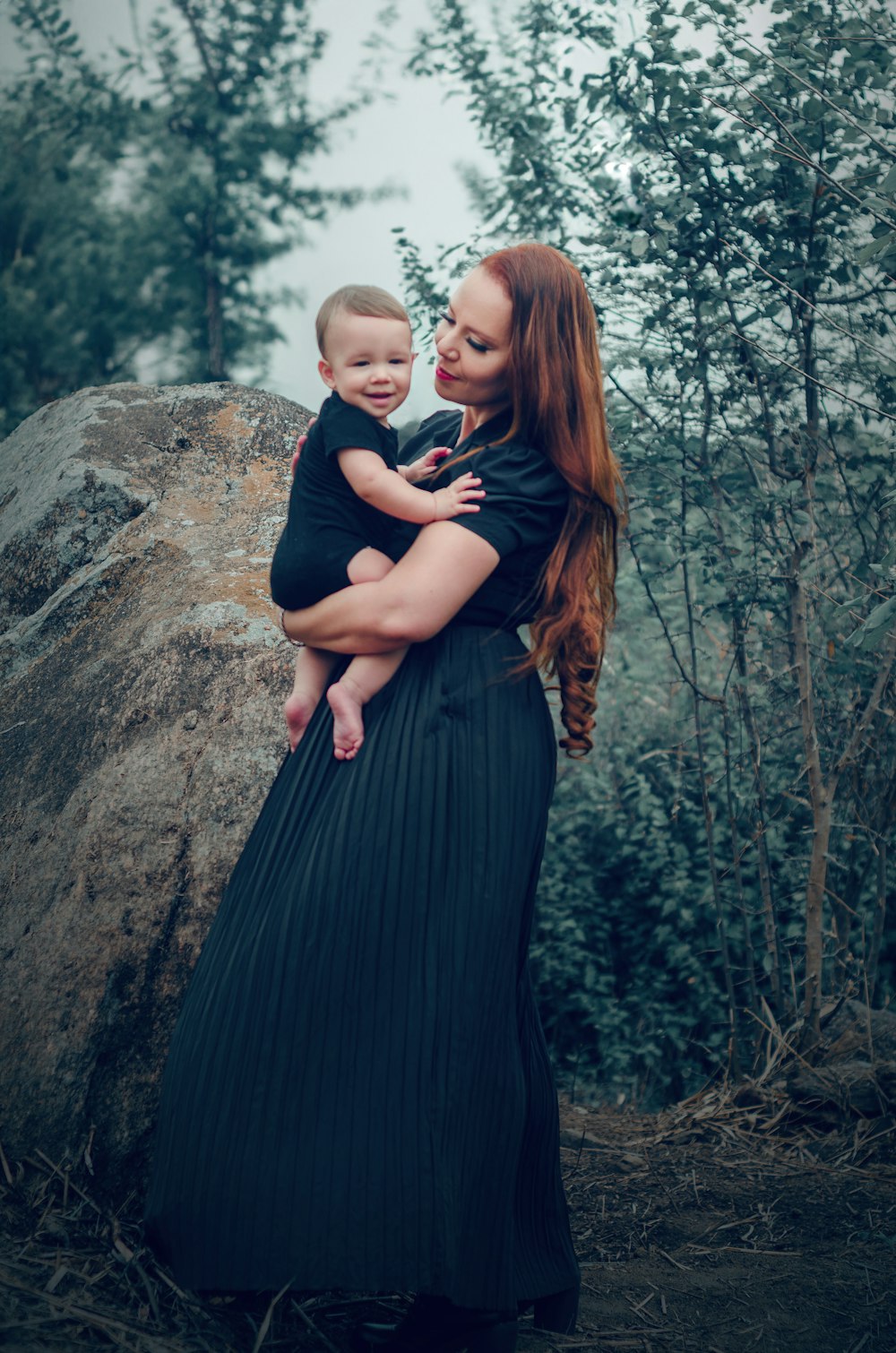 a woman holding a baby in her arms