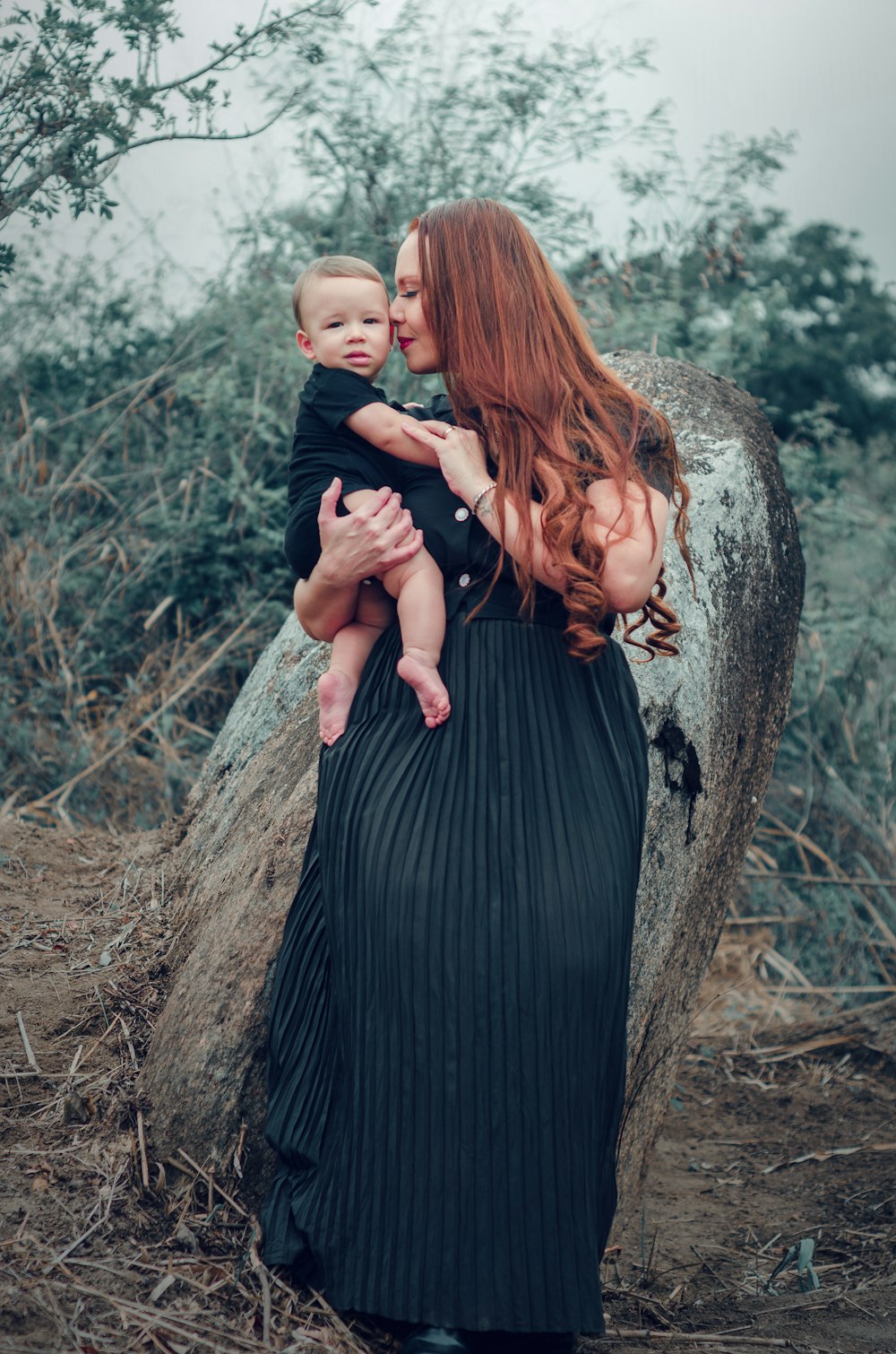 a woman holding a baby in her arms