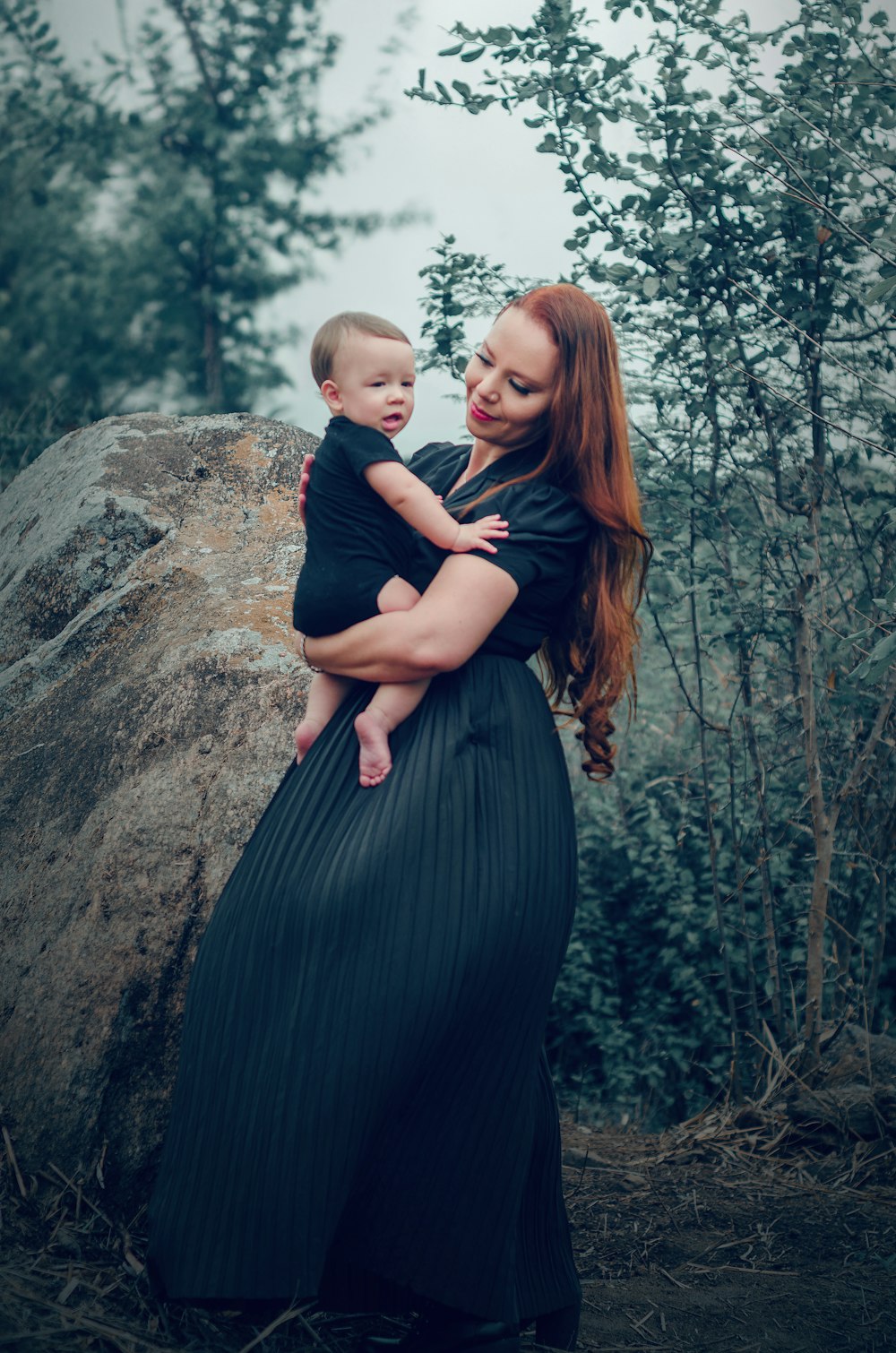 a woman holding a baby in her arms