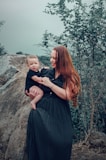a woman holding a baby in her arms