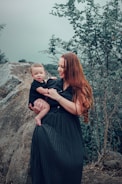 a woman holding a baby in her arms