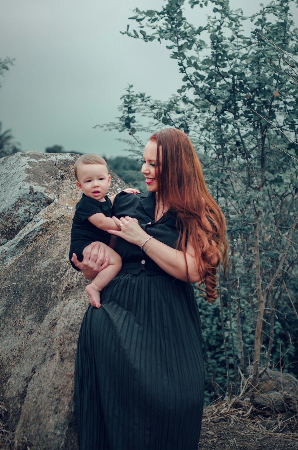 a woman holding a baby in her arms