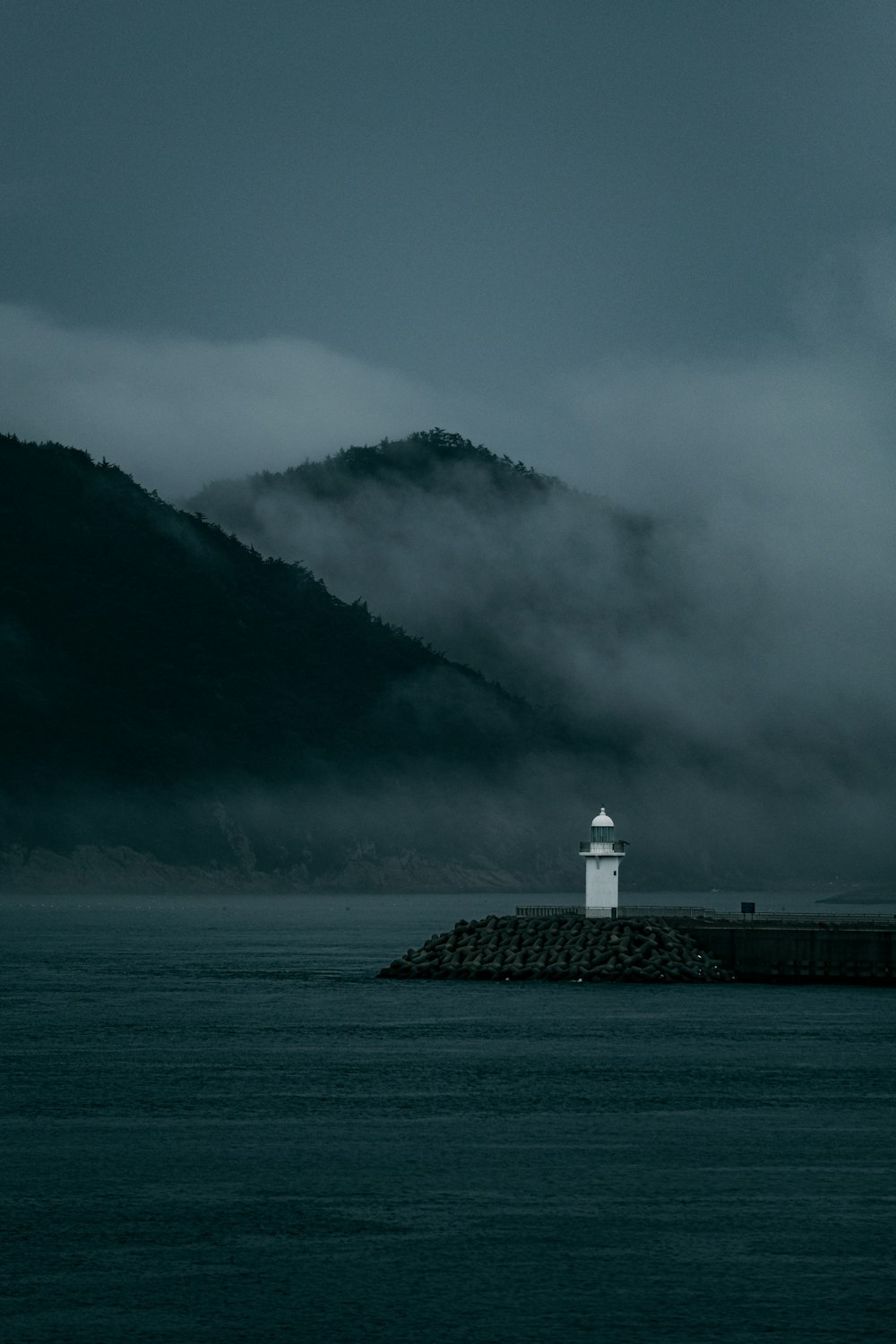 a lighthouse in the middle of a body of water