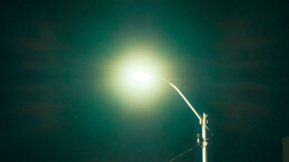 a street light on a pole in the dark