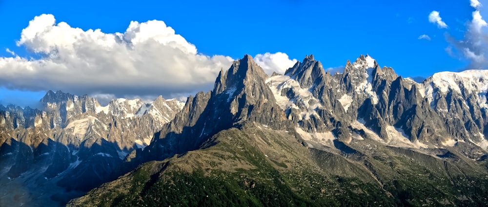 a view of a mountain range with clouds in the sky