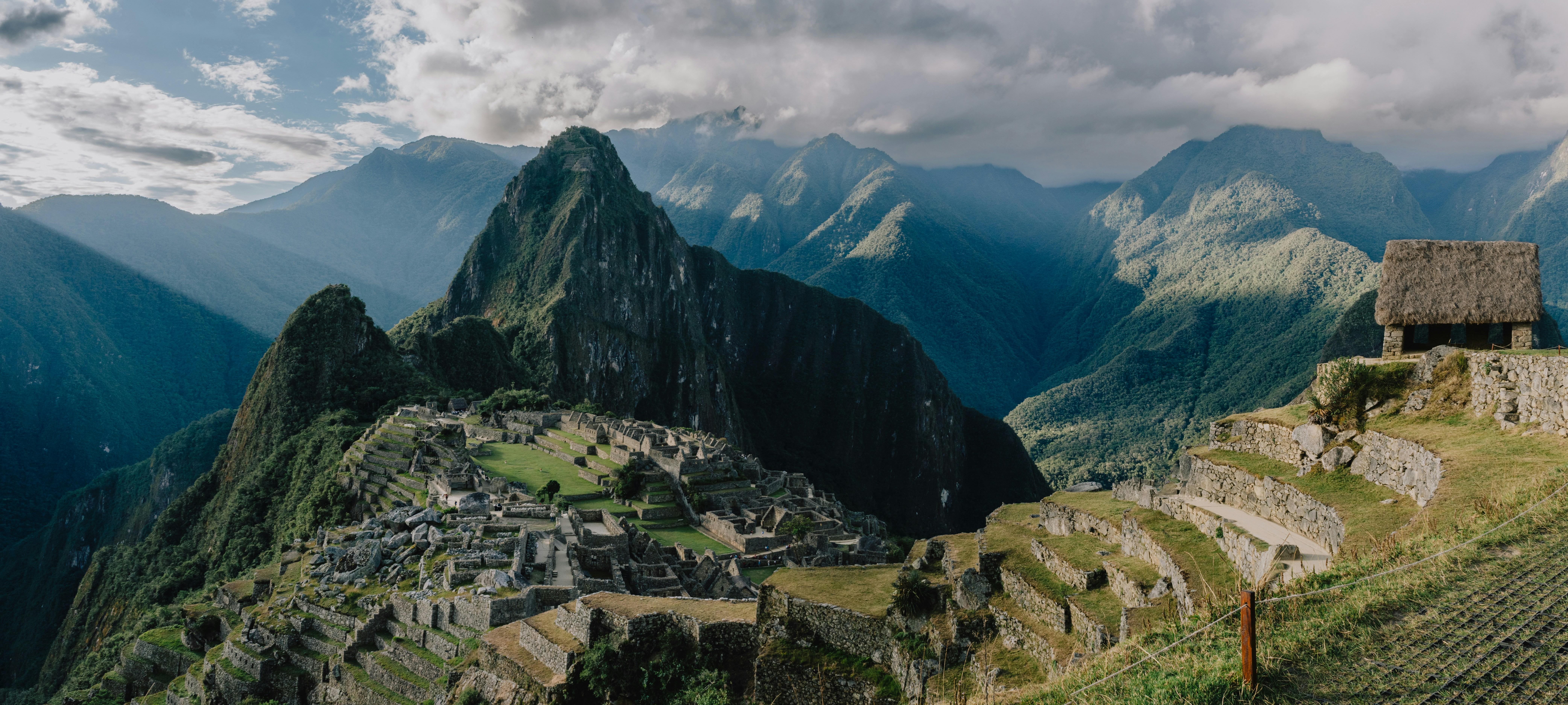 a view of a mountain range with a village in the foreground, 