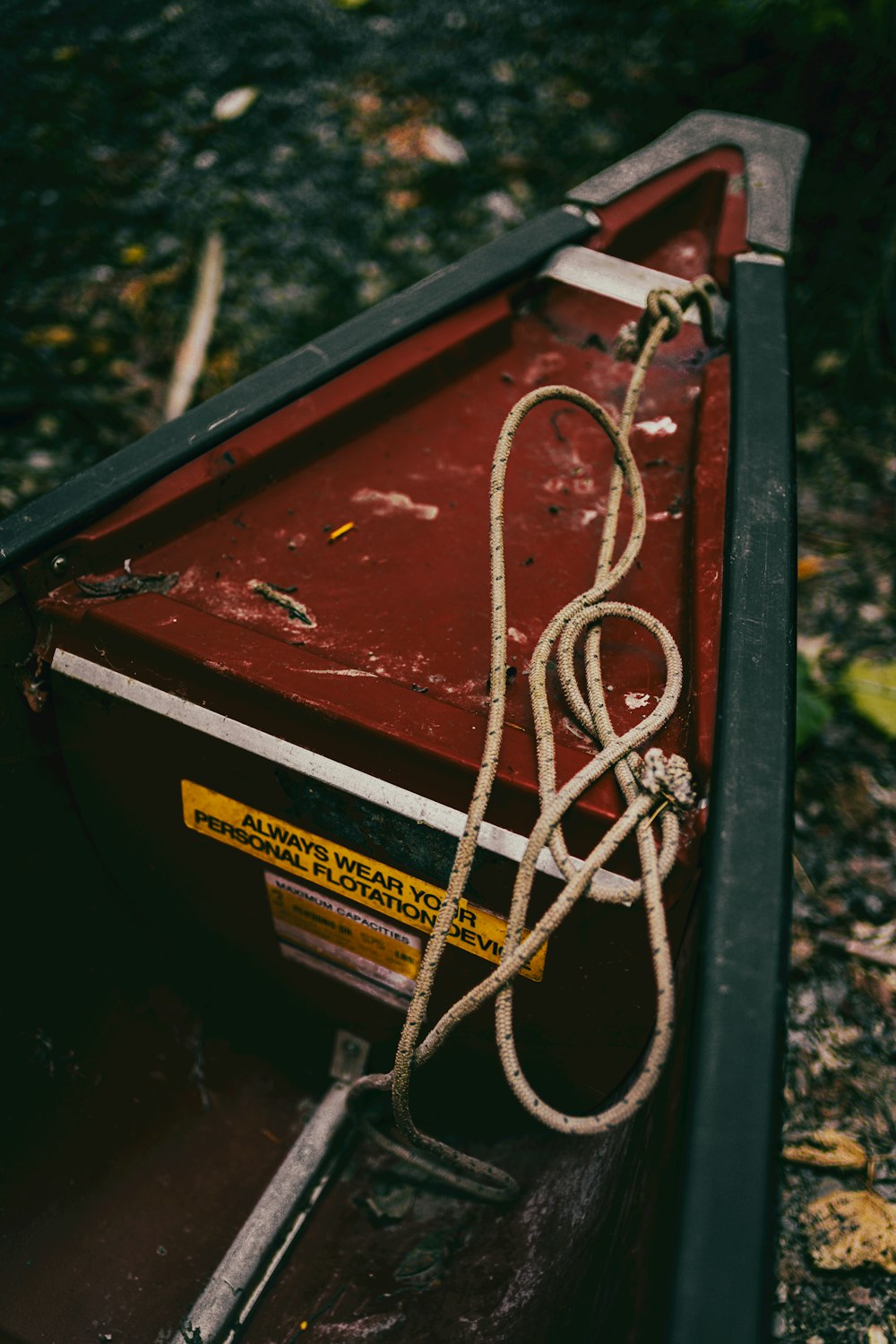 a red boat with a rope tied to it