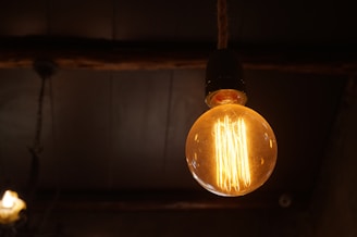 A cozy living room softly lit by a vintage filament bulb lamp.