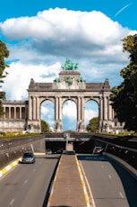 a car driving down a road next to a bridge