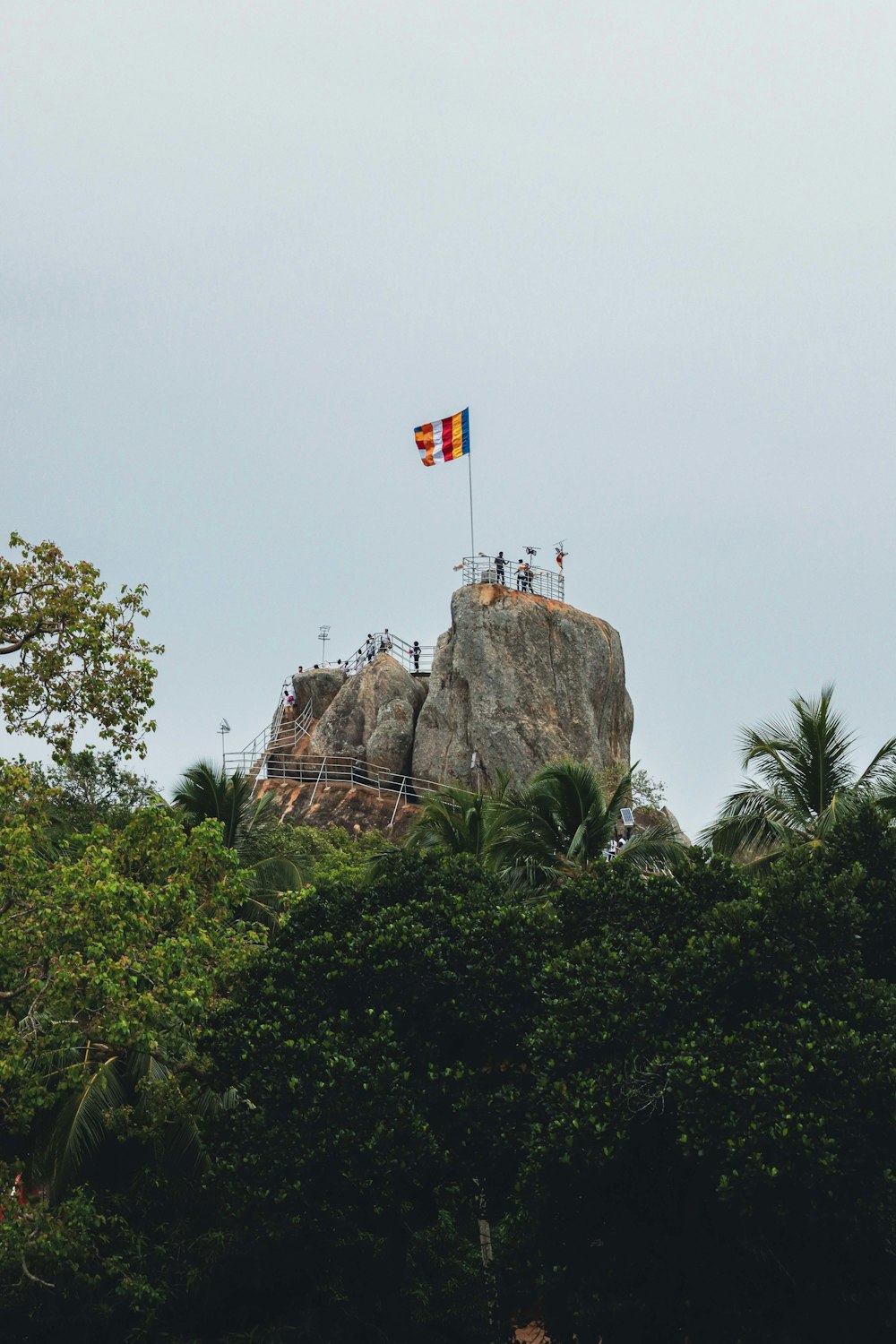 a flag is flying on top of a rock