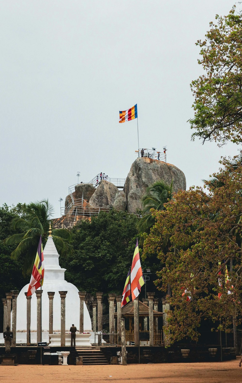 a flag flying in front of a large rock formation