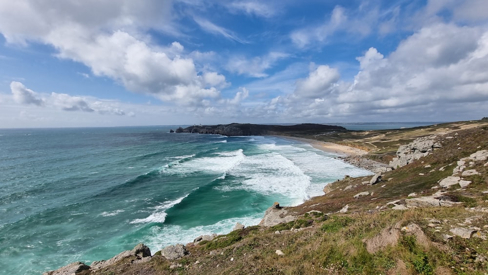 a view of the ocean from the top of a hill