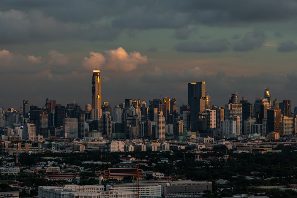 a view of a city skyline with clouds in the sky