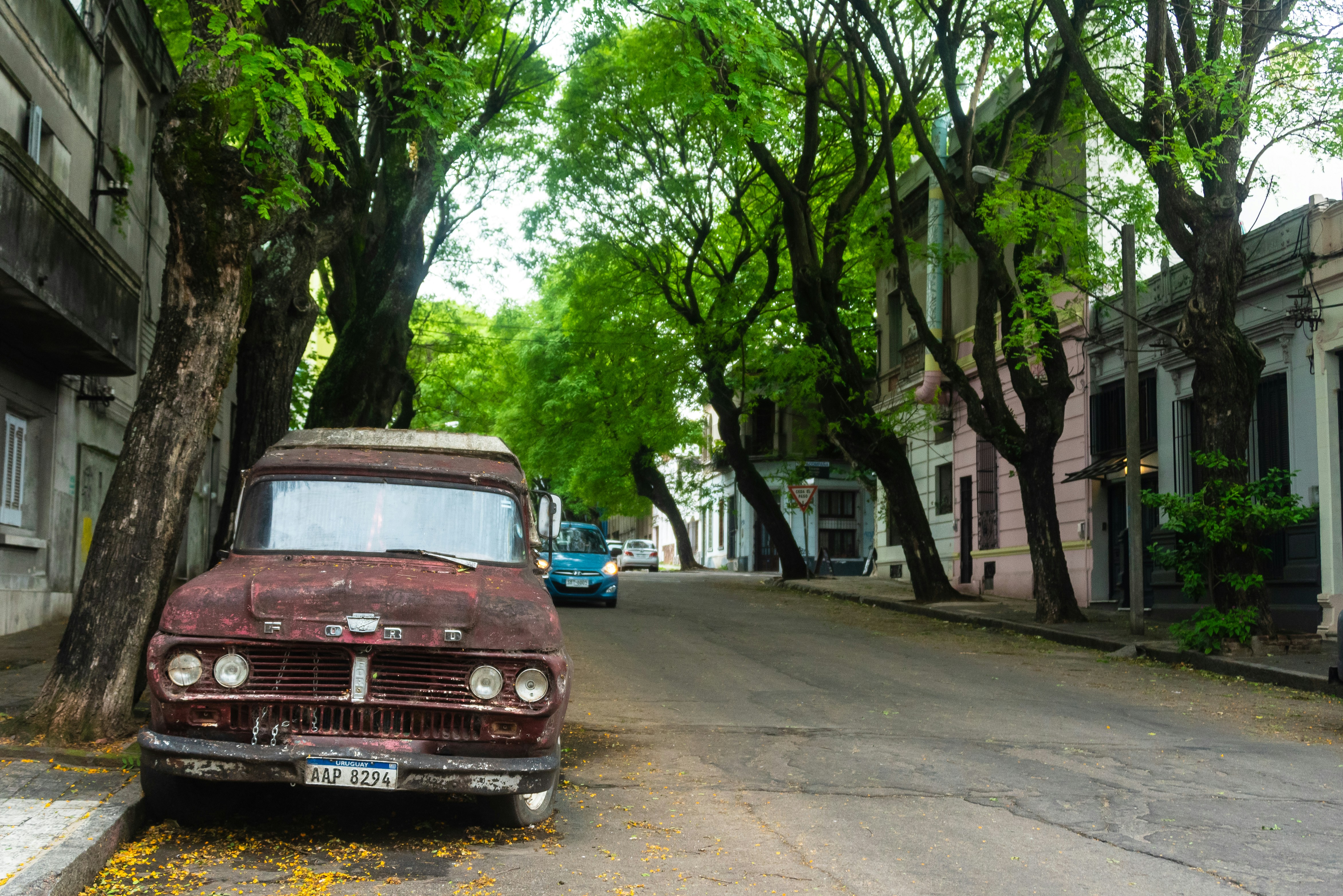 an old truck parked on the side of the road