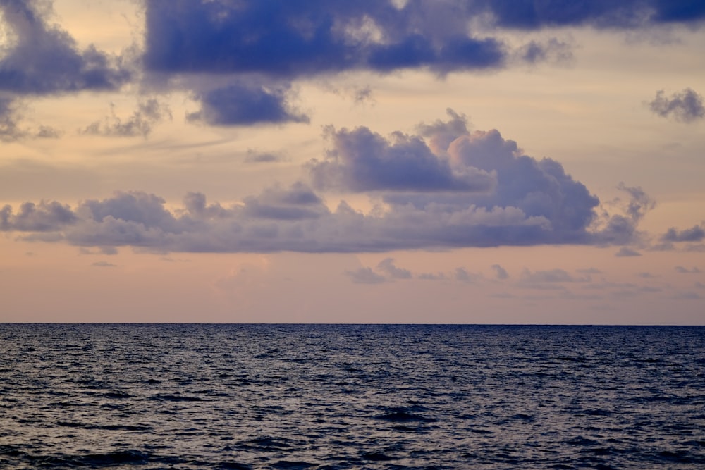 a large body of water under a cloudy sky