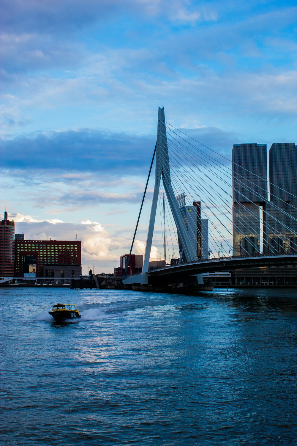 a boat traveling down a river next to tall buildings