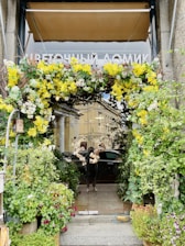 A welcoming entrance of a contemporary residential building surrounded by vibrant flowers.