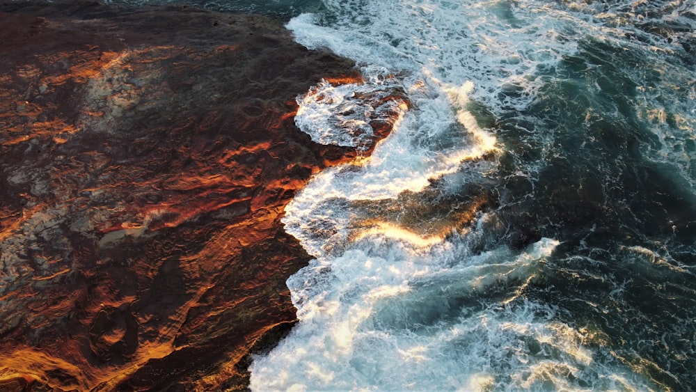 a large body of water next to a rocky shore