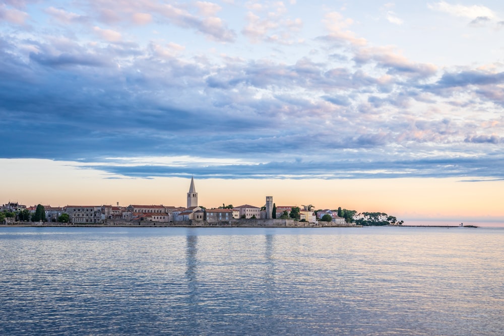 a large body of water with a city in the background