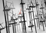 A striking installation piece featuring geometric shapes in soft greys and blacks.