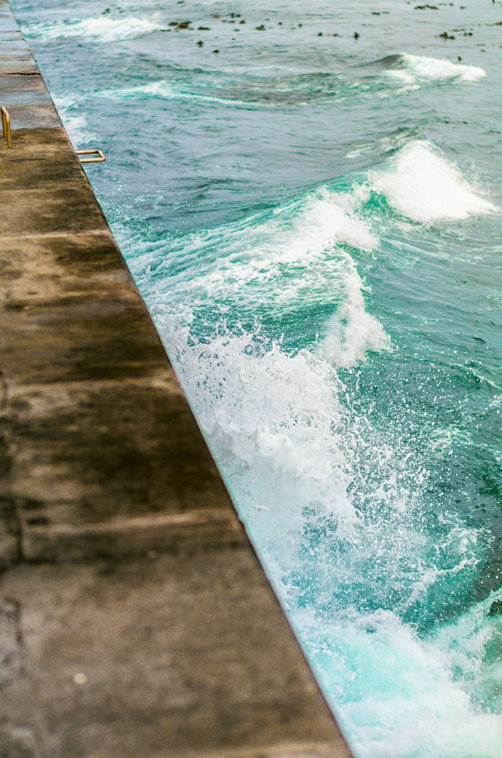 a man riding a surfboard on top of a body of water