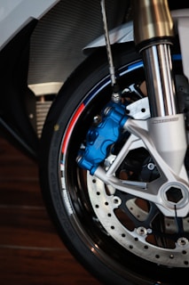Close-up of a shiny motorcycle brake disc and caliper on display