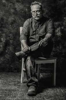 A thoughtful portrait of Andrey Kudeyev surrounded by books and notes, reflecting his deep engagement with philosophy.