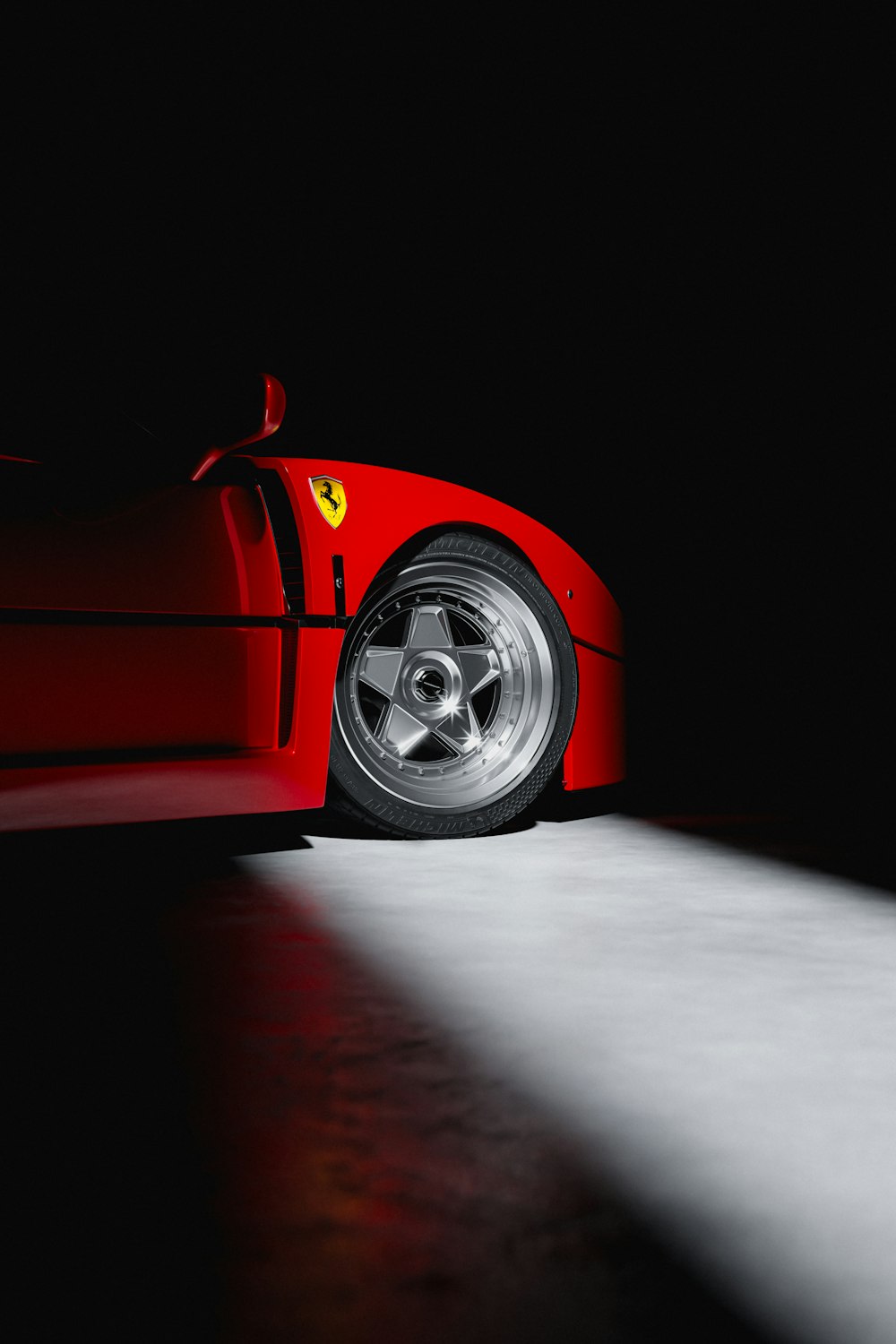 a red sports car parked in the dark